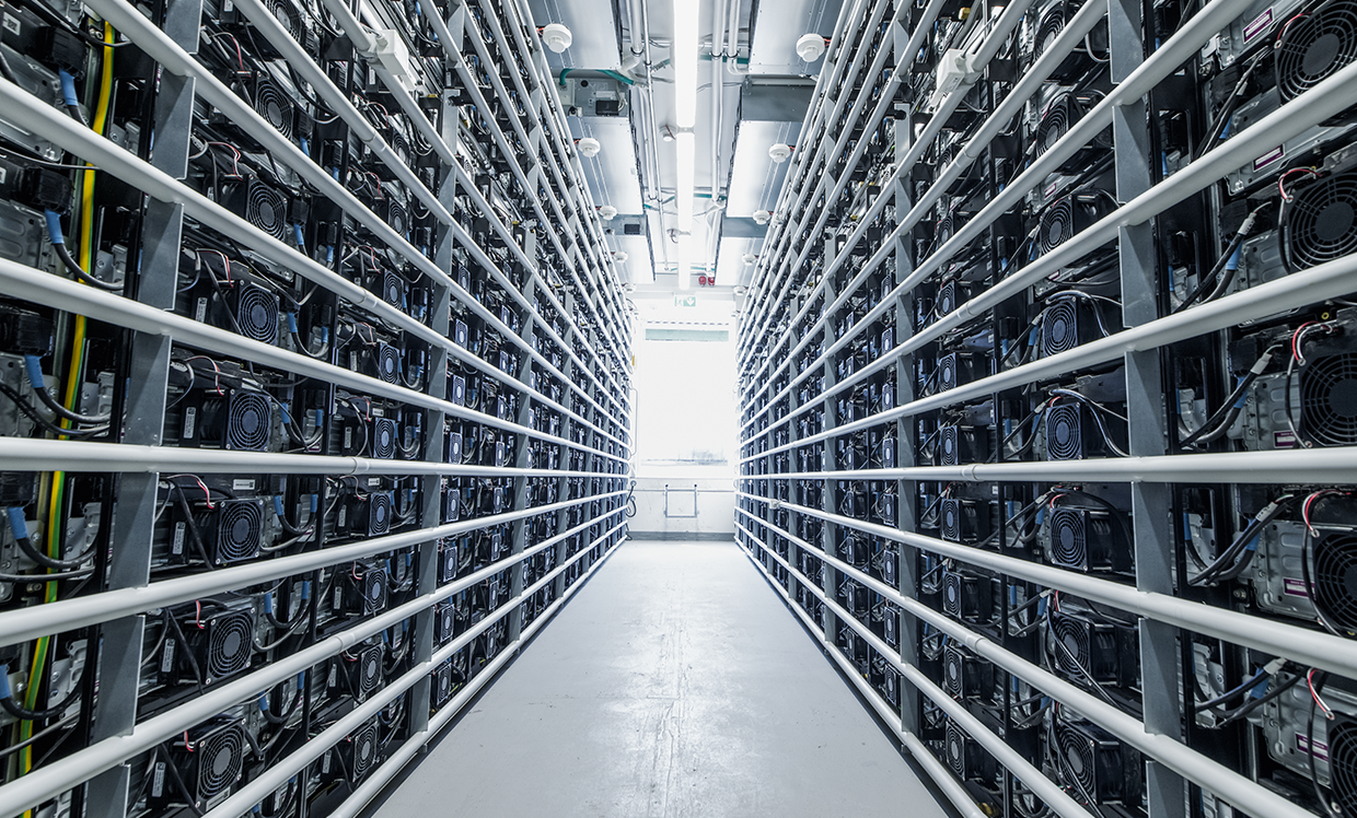 An interior view of a battery storage facility shows numerous battery modules lined up in neat rows. The environment is brightly lit, symbolizing the technological infrastructure supporting renewable energy.